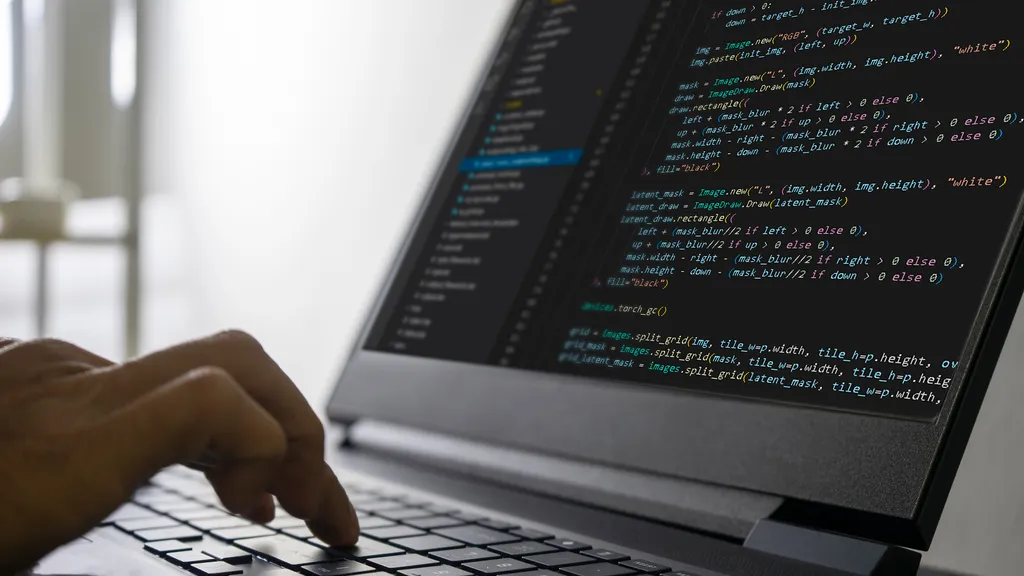 Developer coding on Lenovo laptop